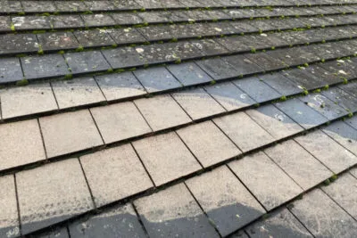 Professional roof cleaning in Worcester, Worcestershire removing moss, algae, and dirt from roof tiles.
