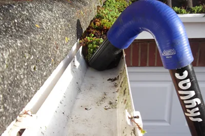 Professional gutter clearing in Worcester, Worcestershire removing leaves and debris from gutters.